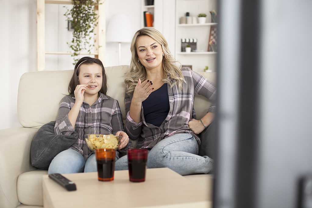 Mother and daughter watching residential TV service